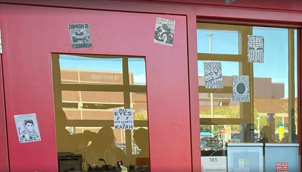 In this May 2024 screenshot at Colorado State University Encampment’s “Rally for Rafah” that DSA Fort Collins co-sponsored,&nbsp;protesters displayed stickers that included depictions of Popular Front for the Liberation of Palestine (PFLP) terrorist Leila Khaled as well as messages that included: “Zionism is terrorism.”