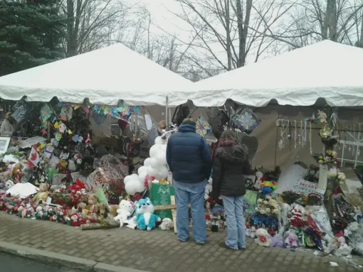 A Sandy Hook Elementary School makeshift memorial on Berkshire Road in Newtown, CT 12 days after shooting of 26 people who were killed, twenty were children.