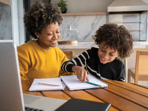 African American mom helping son to study online