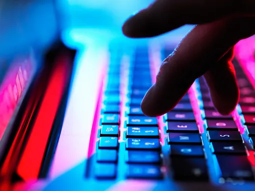 Cloe-up of fingers typing on laptop keyboard