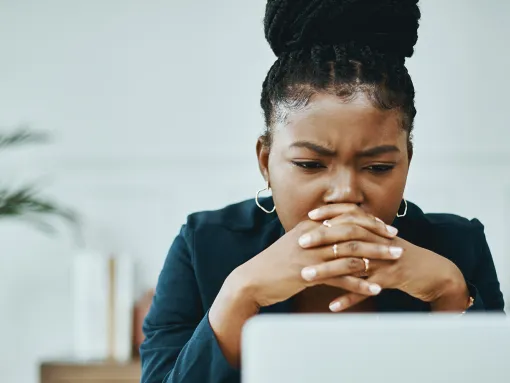 Concerned woman looking at laptop