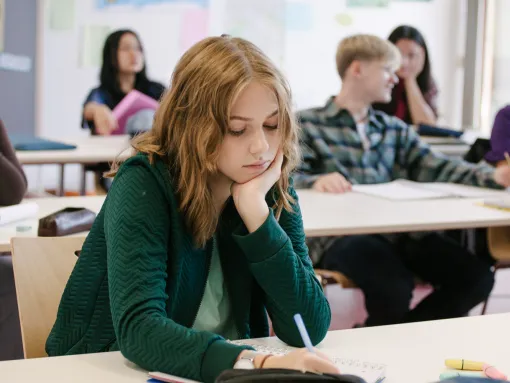 Student concentrating while working in classroom