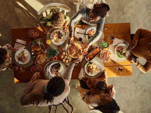 Family eating dinner at the table shot from above