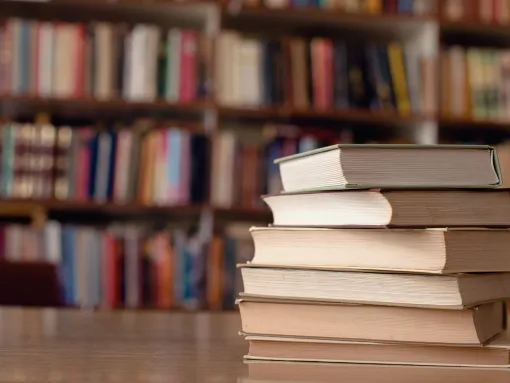 Books stacked on a table in a library