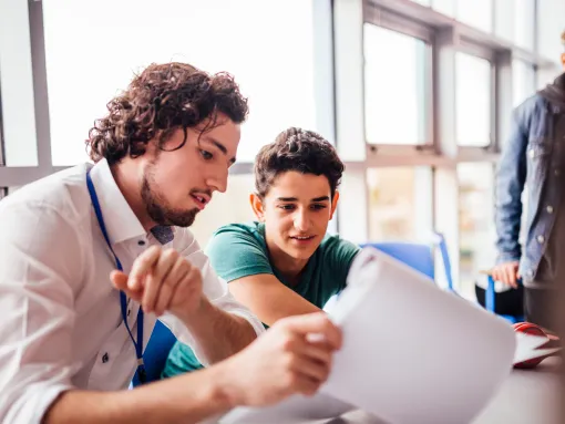 Teacher discussing great school work with student