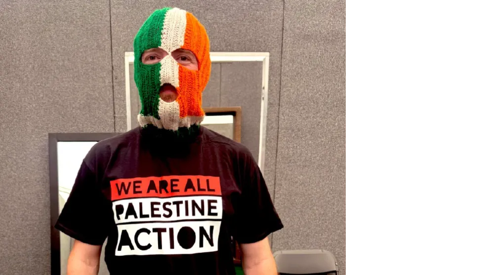 Kneecap band member wearing t-shirt that reads, "We are all Palestine Action"
