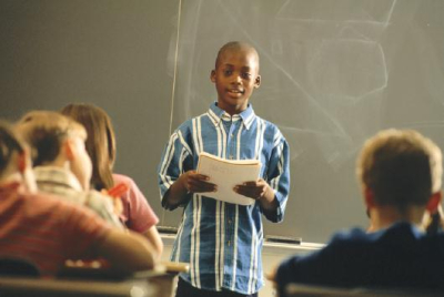 Boy standing in front of class