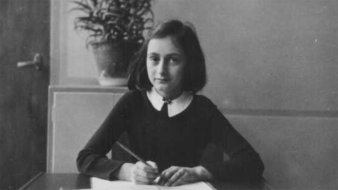 Anne Frank with her diary