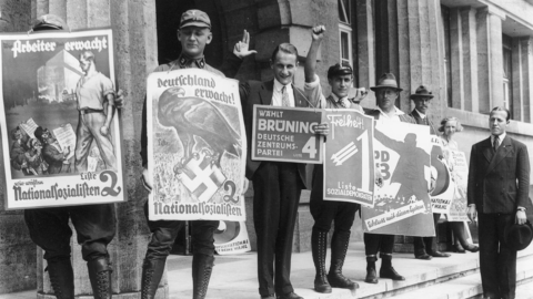 Germans in the street carrying propaganda signage