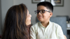 Loving mother embracing son at home